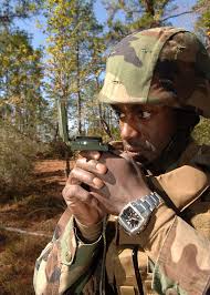 Chief Utilitiesman Michael Gibson, assigned to Naval Mobile Construction  Battalion (NMCB) 133, shoots a heading with a magnetic compass during a  training patrol.