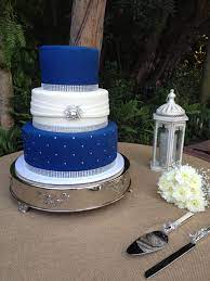 Three Tier Fondant Wedding Cake Royal Blue And White With Bling Ribbon And A Silver Broach Ht Royal Blue Wedding Cakes Royal Blue Cake Silver Winter Wedding
