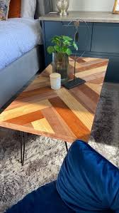 The design is contemporary, and the translucent top a classy vintage coffee table featuring a wonderful base crafted of wrought iron with a bit aged black finish. Intricate Split Herringbone Top Coffee Table With Black Iron Legs Furniture By Penn