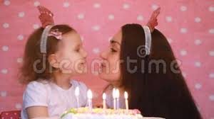 Mother and son celebrating the 1st birthday together. Happy Birthday Mother And Child Make A Wish And Blows Out Candles On Cake At Party Mom Congratulates Embraces And Stock Video Video Of Childhood Background 113912613