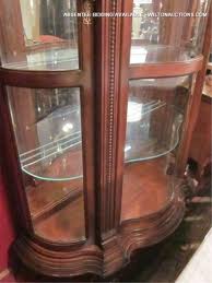 Halogen light with high/low switch. Lot Pulaski Furniture Lighted Dark Wood Cabinet With Glass Shelves Mirror Back And Curved Glass Doors