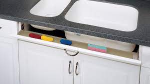 Springs on the hinges keep it closed. Slim Series Tip Out Trays