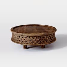 This round shape coffee table is made from mango wood and features a smooth wide top that can be used for serving and various decorative purposes. Carved Wood Coffee Table