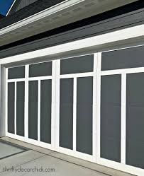 Here's an example of a farmhouse with white wood siding painted solid white. Faux Carriage Garage Door Makeover Thrifty Decor Chick