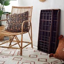 Hanging tassels near the top of the ceiling draw the eye upward without populating the rest of the room and making it messy. Madam Stoltz Htufted Cotton Rug With Tassels Orange Off White