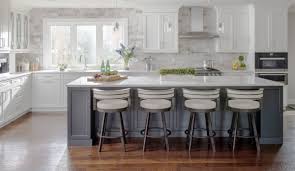 All White Cabinets Grey Island Https Thewoodfloorsource Com Wp Content Uploads 2018 03 Ste In 2020 Kitchen Backsplash Designs White Kitchen Design Kitchen Trends