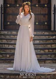 This Modest Bridal By Mon Cheri Tr11977 Ivory Wedding Gown Features An A Line Silhouette In Modest Wedding Dresses Ball Gowns Wedding Mon Cheri Wedding Dresses