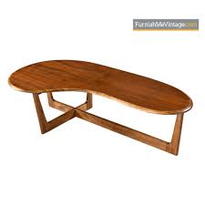 This amorphic coffee table features a beautiful triangular glass top and a swivel architectural base in a dark walnut finish. Amoeba Coffee Table Solid Oak Walnut Boomerang Freefrom Design