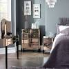 It includes two nightstands and one bed, all made from a blend of solid and engineered wood in a neutral hue. 1