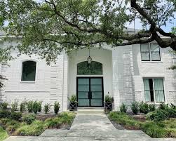 White and black painted brick house. Should You Paint Your Brick House Pros Cons