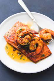 Sweet And Savory Pan Seared Salmon Topped With Sauteed Shrimp In Cajun Butter Sauce Salmon New Orleans Is An Un Seafood Dinner Salmon Dishes Salmon And Shrimp