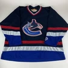 The canucks used versions of the johnny canuck logo for their team jerseys from about 1952 until they joined the national hockey league during the 1970 expansion. Vancouver Canucks Nhl Navy Blue Red Silver Vintage Koho Jersey Mens Xxl Ebay
