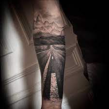 This bike tattoo design is all done in black on the arm of the human canvas. 150 Tattoo Ideas For Mountain Lovers Body Art Guru