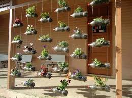 A hanging wall of these bottles on an otherwise open, exposed porch or pergola would also create a it includes instructions, as well as a templates for cutting openings as well as a template for adding a decorative label. 25 Plastic Bottle Vertical Garden Ideas Soda Bottle Garden