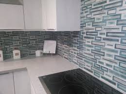 This kitchen features brown fantasy leathered quartzite countertops paired with a glass tile backsplash. 3 Blue Kitchen Backsplashes You Ll Love