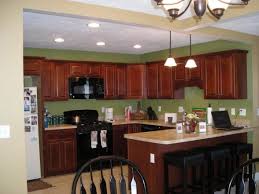 Green kitchen cabinets at the bottom and white ones at the top…what a chic combination those wooden compartments at the top are a really cool feature too and the stainless steel appliances don't look out of black and white are the primary colors used in this kitchen but green is just as important. Pin On Recipes