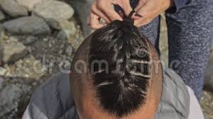 Maybe you would like to learn more about one of these? Man S Hair From Pigtails Woman Braids The Hair Of A Man Boy Does A Viking Hairstyle Weave Hair Near A Mountain River Stock Footage Video Of Design Braid 130568604
