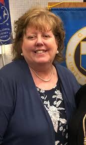 Members of the GFWC Pigeon Area Woman's Club pose for a photo with Village  President, Mike LePage at the Memorial Day Service