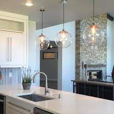 Whether you are enjoying familiar sunday brunches, holiday gatherings while cooking, or simple weeknight dinners, a rectangular or oval chandelier over the kitchen island or long dining table spreads light perfectly for prepping food or romantic dining. Olapic Kitchen Lights Over Island Kitchen Room Design Kitchen Design