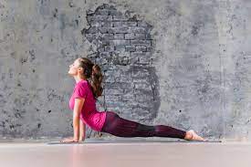 Doctor said that stretching would be a good idea. Free Photo Yoga Fitness Woman Practicing Stretching Exercise Against Concrete Wall