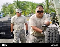 U.S. Air Force Staff Sgt. Joel Fernandez (left) and Tech. Sgt. Kyle Kikuchi  (right) push a CDK Mobile Systems Dolly Set M1022A1 while setting up the  Eagle Vision work site, Clark Air