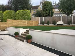 Modern Garden Split Level Garden Rendered Walls Cream Porcelain Patio And Sun Terrace Between The Spacious Terra Modern Garden Sloped Garden Patio Garden