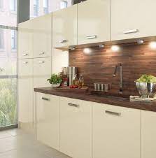 Walnut kitchen with pelmet lighting. Love The Dark Wood Worktop And Splashback Against The Vanilla Gloss Cupboards Wood Worktop Kitchen Worktop Kitchen Design