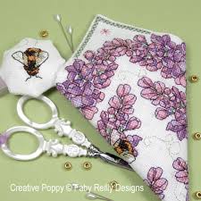 Model stitched on 14 count black aida. Faby Reilly Designs Lilac Scissor Case And Fob Cross Stitch Pattern