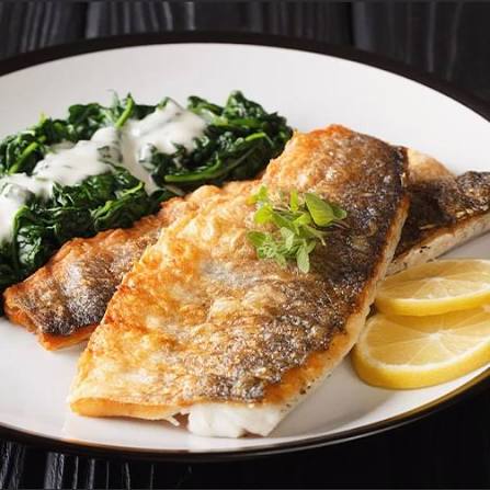Cleaned Safi rabbitfish with traditional Gulf spices and marinade prepared on wooden board