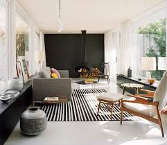 Black Accent Wall Living Room A Hanging Fireplace And Black Accent Wall Stand Out In This Modern Living Room Atrium House Mid Century House House Interior