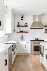 Diagonal patterned ceramic tiles as backsplash has simple black color and they team up together with black hardware. 70 White Cabinets With White Countertop Going Out Of Style