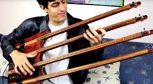 Guy Plays A Four Neck Bass Guitar With One String Per Neck Because He Can Shouts