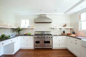 Wall cabinets stacked as base and tall cabinets from floor to ceiling create an accent wall that can house everything from cookbooks to appliances. U Shaped Kitchen With Backsplash Tiles That Do Not Go Up To The Ceiling Transitional Kitchen