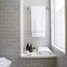I had wanted white cabinets with white subway tile, but my cabinets ended up having a yellow undertone, so i went with a light gray subway tile, and yes the grout decision took a while, but ultimately i matched the grout with the tile for a seamless look. Gray Subway Tile Shower Design Ideas