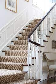 A stair runner fulfils a number of functions: J K Kling Design Wonderful Sisal Stair Runnner With Panel Moulding And White Walls Staircase Design Stairs Design Staircase Runner
