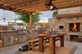 A rustic outdoor entertaining kitchen in dallas features a bar using neolith countertops. 15 Farmhouse Style Outdoor Kitchens That Will Blow Your Mind