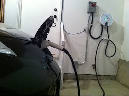 Charge Your Electric Car At Home Shown Nissan Leaf Home Charger Be Sure To Equip Your Garage With A 220 V Outle Electric Car Charger Hybrid Car Electric Car
