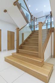 Winding modern staircase with glass railing from upper landing in 2 story foyer in a modern home. Glass Balustrade Stairs Google Search Staircase Design Stairs Design Timber Staircase