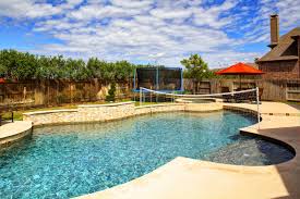 Free Form Swimming Pool And Spa With Volleyball Net Inset Tiered Spa And Waterfall Wall Spray Deck And Traver Backyard Pool Designs Dream Pools Backyard Pool