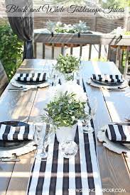 The high contrast look is amplified by a black dining set and white kitchen cabinetry. How To Make A Beautiful Black And White Tablescape Setting For Four