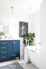 A vessel sink adds a sculptural touch and retains the authenticity of the table. Beautiful Spa Bathroom With Navy Blue Vanity Spa Master Bathroom Bathroom Freestanding Blue Vanity