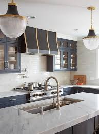 Black And Gold Kitchen Cabinets Matte Black Gold And White Glass Pendants Hang Above A Dark Gray Island Fitted With A Thick White Quartz Co Home Custom Kitchen Appliances Best Kitchen Sinks