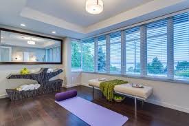 Bright, seafoam green walls and fitness essentials such as a rubber tile floor, a ballet barre, a basic bench and mirrors make for an inviting workout space. 10 Home Yoga Studio Designs You Ll Love