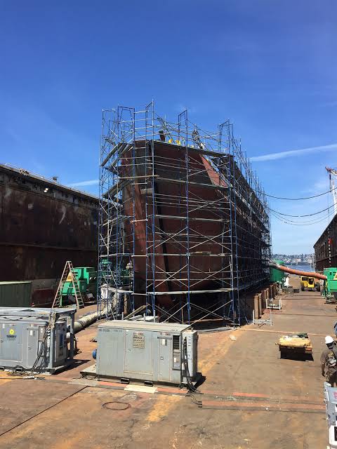 Hull scaffolding erected around a ship in a drydock for repair work