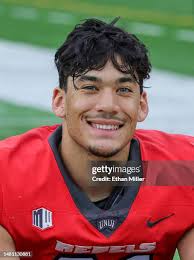 Defensive back Johnathan Baldwin of the UNLV Rebels is tackled by... News  Photo