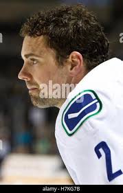 Vancouver Canucks defenseman Dan Hamhuis (2) tries to clear Calgary Flames  left wing Michael Ferland (79) from in front of Vancouver Canucks goalie  Eddie Lack (31) during the first period of game