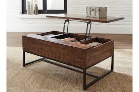 A dark stained asian hardwood and veneer flip top coffee table. Hirvanton Coffee Table With Lift Top Ashley Furniture Homestore