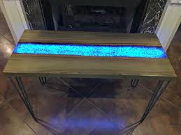 Sealing the live edge brush the live edge with epoxy to stop air bubbles from leaking out of the edge. This Live Edge River Table Glows In The Dark Adding Life To Your Interiors