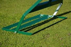 Dealing with a moderately uneven lawn. Levelling Lute Specialist Greenkeeper Tools