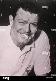 Texas football coach Darrell Royal and Tennessee coach Doug Dickey, right,  have a laugh during a joint news conference in Dallas, Dec. 30, 1968. Their  teams will meet in the Cotton Bowl